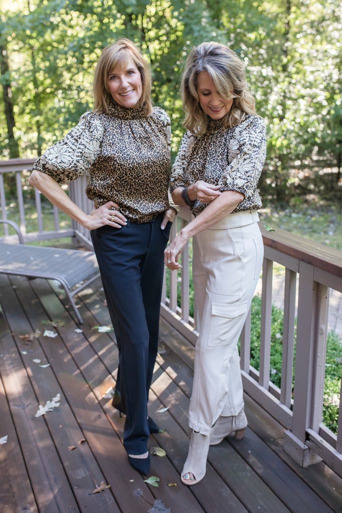 Leopard print short sleeved blouse shown with black pants and off white pants