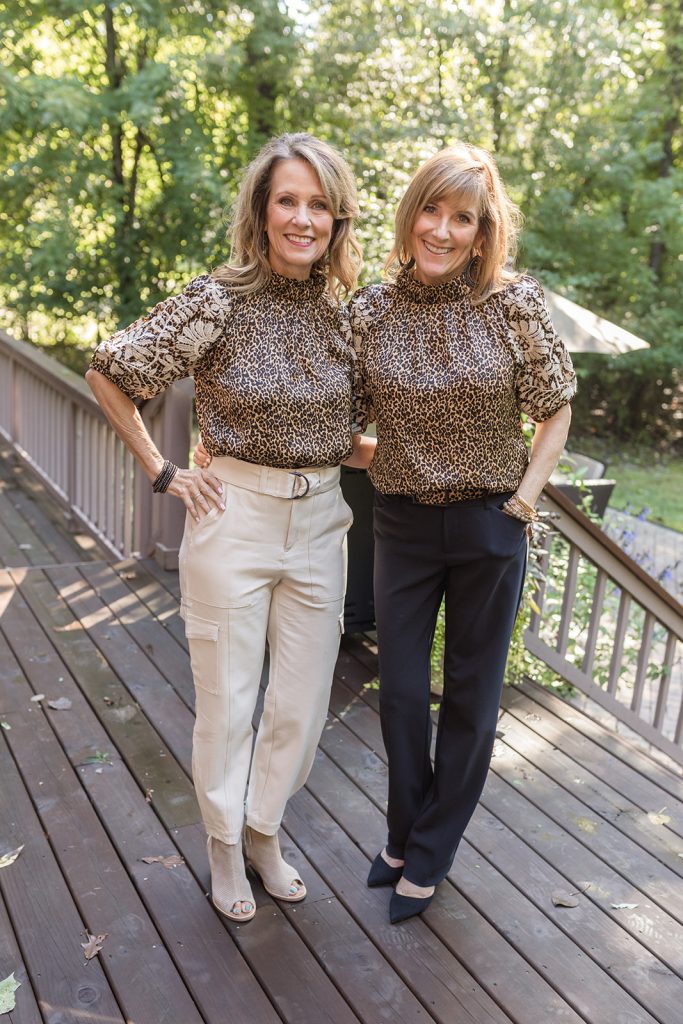 Leopard print short sleeved blouse shown with black pants and off white pants