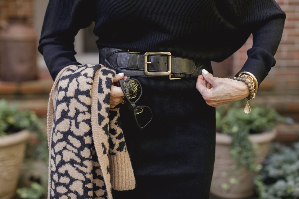 Bev in black dress with black belt, black sunglasses, and black leopard print scarf