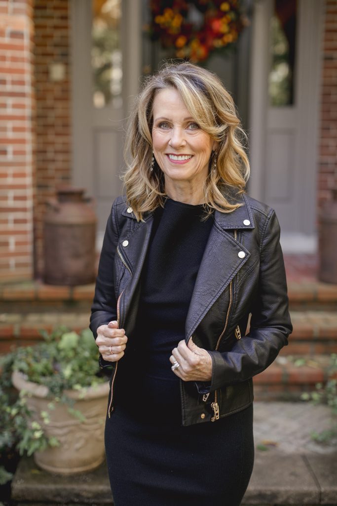 Val in black dress and black leather moto jacket