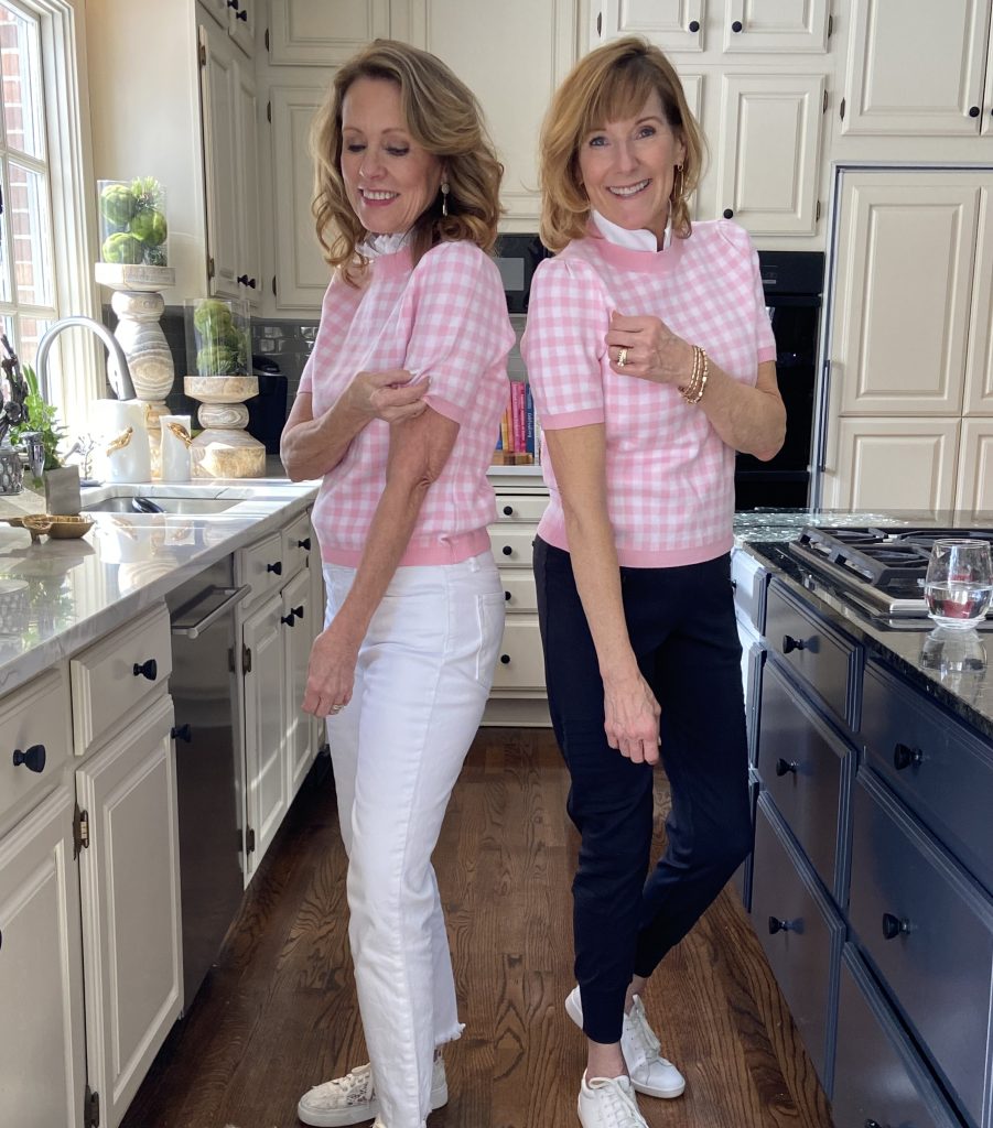 two women wearing the same sweater