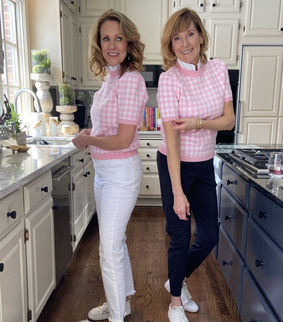 two women wearing the same sweater