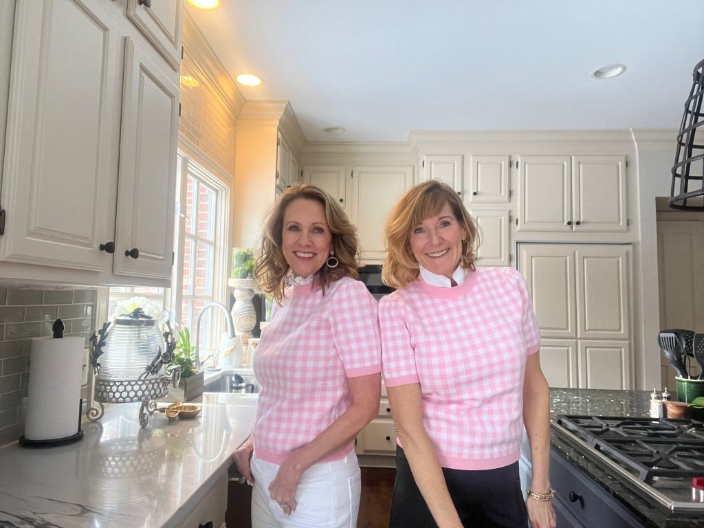 two women wearing the same sweater