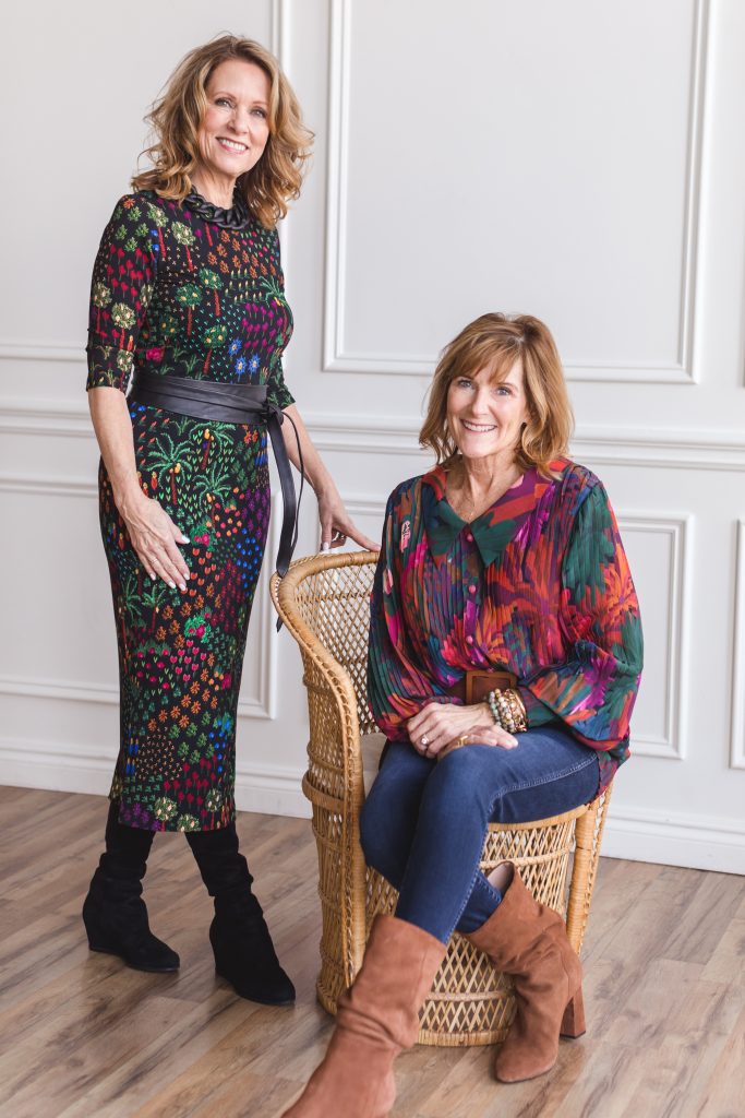 two women one wearing a dress the other wearing tunic and pants