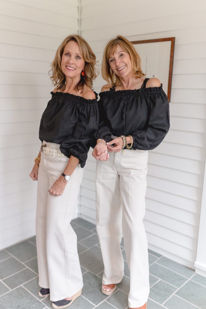 Women with Black Tops and Off White Jeans