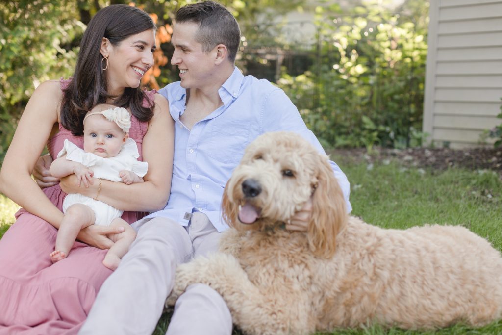 Photo of three people and a dog